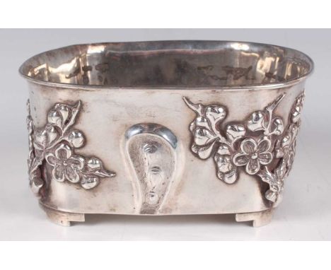 A Chinese export silver jardinière, late Qing dynasty, of naturalistic trunk form, the sides decorated in relief with blossom