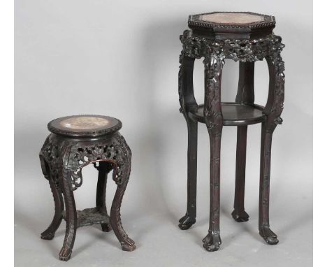 A Chinese hardwood stand, late 19th/early 20th century, the octagonal top inset with a rouge marble panel within a carved scr