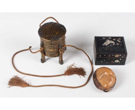 A Japanese lacquer miniature hokai box and cover, Meiji period, of ribbed cylindrical form, raised on four upright flange leg