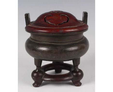 A Chinese wire inlaid brown patinated bronze tripod censer, 18th/19th century, the squat circular body inlaid with bamboo and