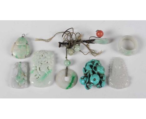 A small group of Chinese jade, 20th century, comprising a silver mounted Buddha pendant, length 3cm, three other pendants, a 