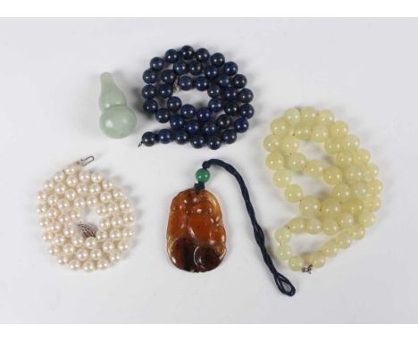 A Chinese agate pendant, carved and pierced with fruit, length 5.5cm, a Chinese jade gourd shaped snuff bottle, height 5cm, a