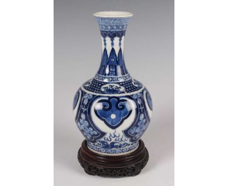 A Chinese blue and white porcelain bottle vase, mark of Kangxi but probably late 19th century, the flared neck painted with r