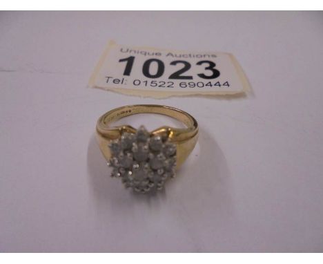 A gold cluster ring, size J half, 3.7 grams.