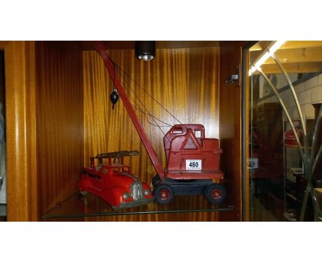 A pressed steel Tri-ang crane and an early fire engine
