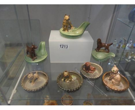 Three Wade pipe stands and four animal pin dishes.