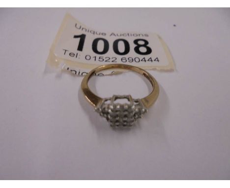 An oblong 9 stone flanked 6 stone diamond ring, size O half, 1.5 grams.