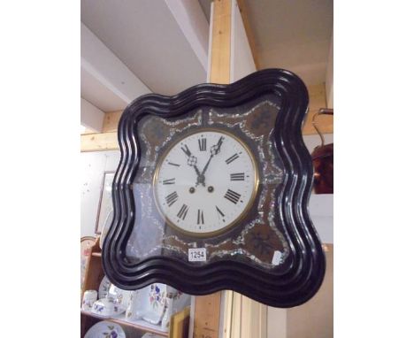 A 19th century 8 day wall clock with mother of pearl decoration.