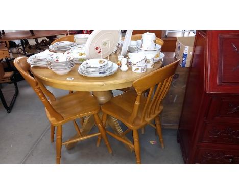 A solid light wood round-to-oval extending dining table and 4 chairs D105cm H79cm, COLLECT ONLY