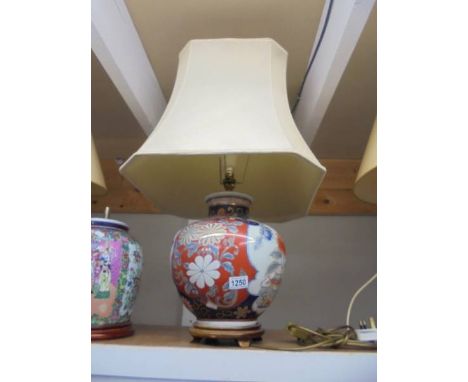 An oriental ceramic table lamp with shade. COLLECT ONLY.