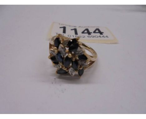 A diamond sapphire cluster ring, 11 marquise cut sapphires and 8 diamonds in a 9ct gold setting and shank.