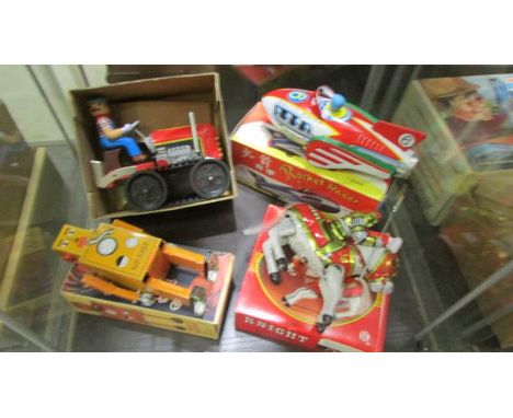 Four boxed tin plate clockwork toys including Robot, Knight, Rocket racer and bulldozer.