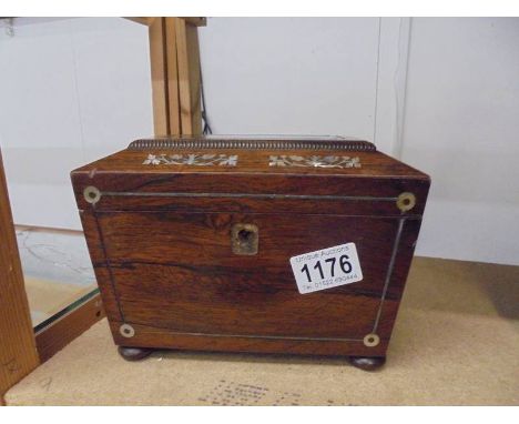 A Victorian rosewood tea caddy inlaid with mother of pearl (missing escutcheon and one side ring.).