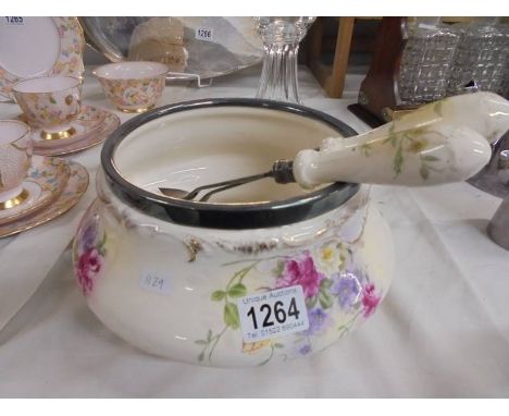 A ceramic salad bowl with plated rim and a pair of salad servers.