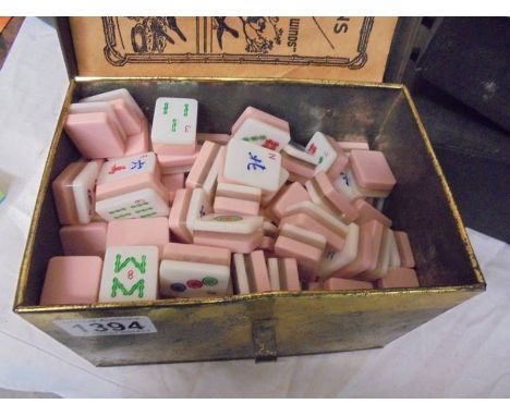 A vintage Mahjong set in a tin box.