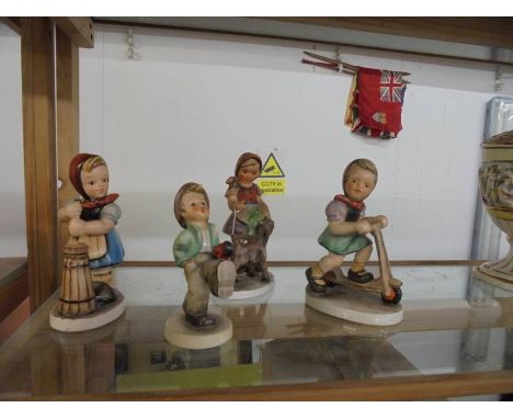 Three Friedel Bavaria girl figures and a Goebel boy figure.