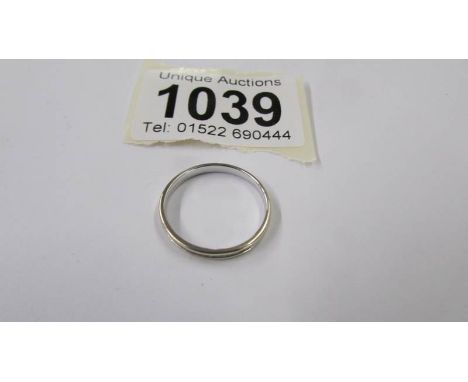 A platinum wedding ring, size O half, 2 grams.