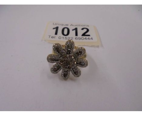 A large floral diamond and yellow gold ring, size M, 4.4 grams.