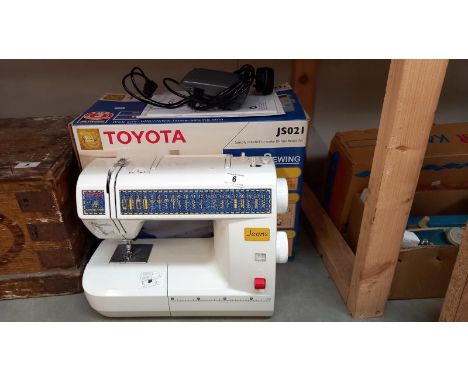 A boxed Toyota JS021 sewing machine. COLLECT ONLYNot PAT tested.Plugged in, the light came on & needle went up & down when te