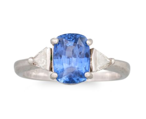 A SAPPHIRE AND DIAMOND THREE STONE RING, the oval sapphire to trillion cut diamond sides, mounted in platinum. Estimated: wei