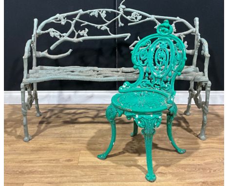 A cast iron faux bois garden bench, in the manner of Coalbrookdale, 87cm high, 133cm wide, 55cm deep; a cast iron chair, 81.5