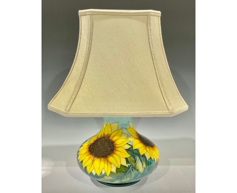 A contemporary Moorcroft Sunflower pattern compressed ovoid table lamp, tube-lined in tones of yellow, green and blue, 20cm h