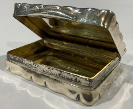 A silver shaped rectangular snuff box, the hinged cover inscribed 'The South Wales Ladies Team To Their "Mascot" Tenby 1934',
