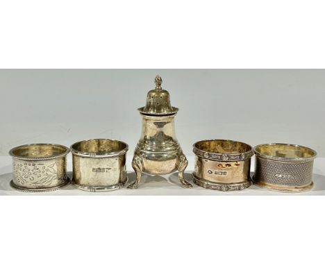 A silver pepper pot, Birmingham 1960; a silver napkin ring, Sheffield 1907; other silver napkin rings; 149g (5) 