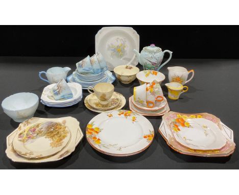 A Shelley Art Deco part tea service, decorated with tree and flowers on pale blue ground, comprising cake plate, side plates,