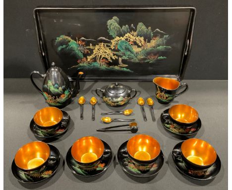 A mid century Japanese style lacquer and gilt tea service for six, depicting a river scene with houses and background mountai
