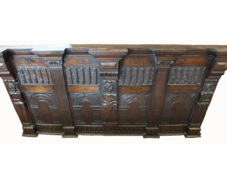 A carved Oak overmantel, the central panel with applied female standing figure carving flanked by two male figures, 17th Cent
