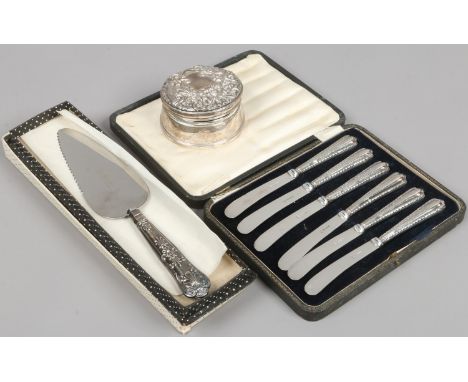 A silver trinket box along with a cased set of silver handled knives and a silver handled pie server.