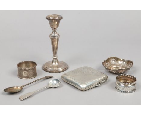 A quantity of silver items including a weighted candlestick, cigarette case, napkin rings, teaspoon etc.