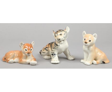 Three Russian Lomonosov ceramic animals, formed as a tiger cub and two lion cubs.