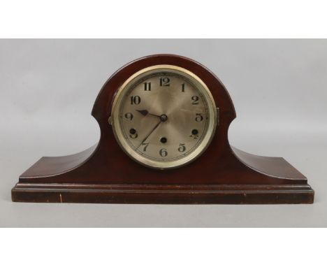 A mahogany cased mantle clock housing three train movement with pendulum and key.