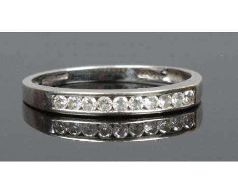 A 9ct white gold and diamond channel set ten stone half eternity ring, size R.
