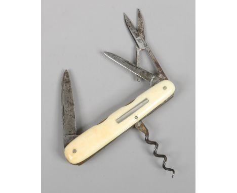 An antique multi tool pocket knife with ivory scales and milled brass liners by Harrison Bros.