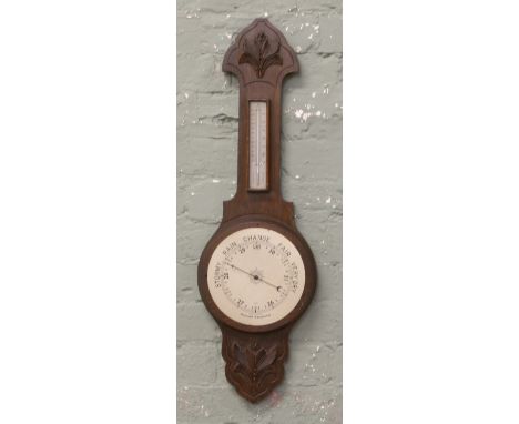 An oak banjo barometer in need of restoration.