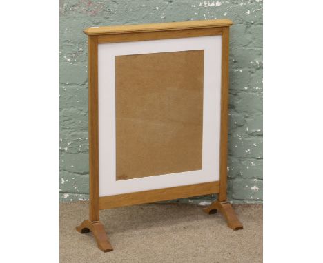 A light oak firescreen.