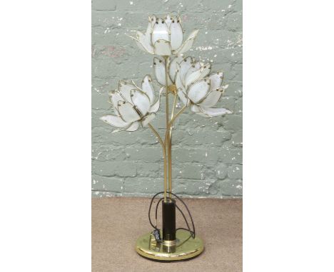 A brass effect four branch standard lamp of floral form.