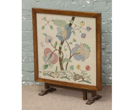 An oak framed metamorphic firescreen/occasional table.