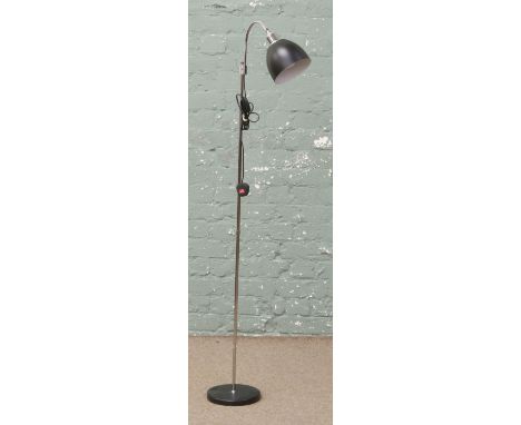 A chrome reading lamp with matt black shade.