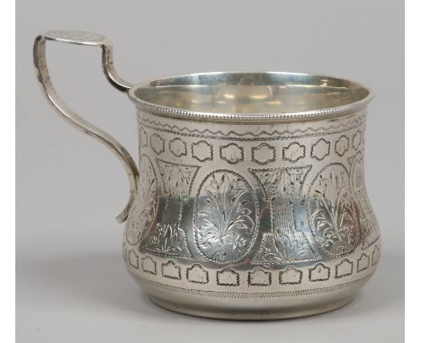 A Russian silver cup with chase engraving decoration stamped 1876 to the base, weight 103 grams.