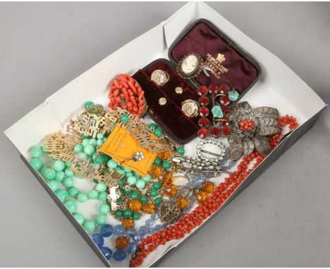 A box of vintage dress jewellery including coral, white paste spray brooch and jade coloured hardstone etc.