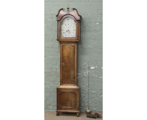 A George III oak eight day longcase clock with swan neck pediment and painted dial.