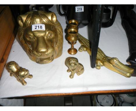 A quantity of brass items including crocodile nut cracker & large lions head etc.