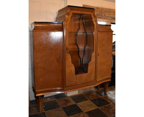 A Continental Art Deco burr walnut display cabinet fitted central astragal glazed section flanked by panel doors enclosing sh