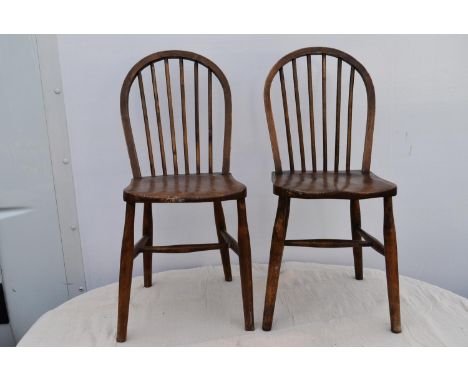 A pair of elm stick back dining chairs. 