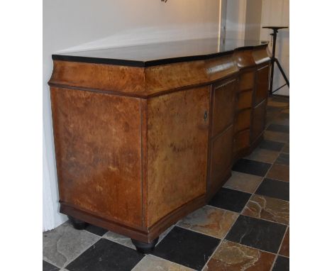 A Continental Art Deco bird's eye walnut and ebonised sideboard fitted with central bank of fitted cutlery drawers flanked by