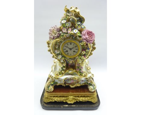 19th century Rococo style porcelain mantel clock, cartouche shaped with hand painted flower head and foliage decoration, on s